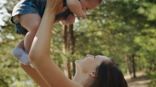 Beauty Mum And Her Child Playing In Park Together