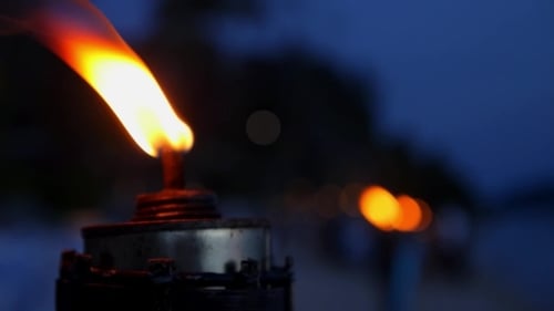 Burning Fire Torch In The Night On The Beach.