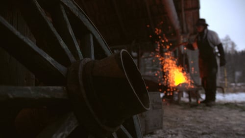 Blacksmith Forging Metal in Winter Rural Scene