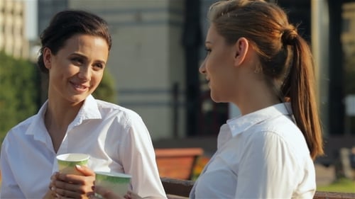Two Women Chatting Over Coffee Outside