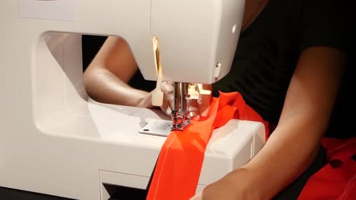 Red Fabric To Sew on the Sewing Machine. Close Up