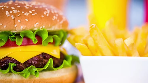Close Up Of Cheeseburger With Fries