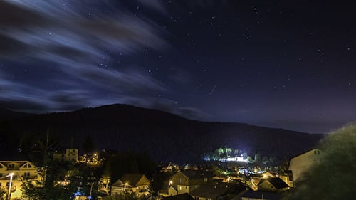 Stars Moving In Night Sky Over Mountain City