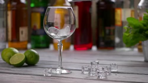 Ice Cubes Falling Into Glass