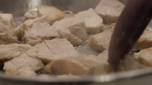 Fresh meat in frying pan 4K 2160p 30fps UltraHD video - Poultry pieces on oil close-up 3840X2160 UHD