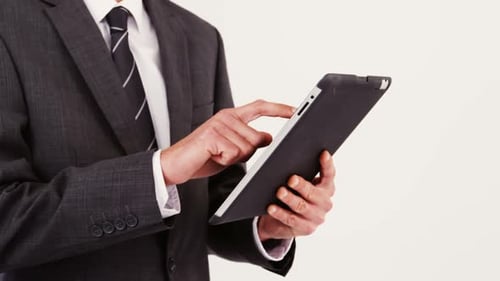 Mid-section of businessman using digital tablet