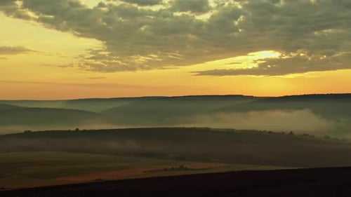 Misty Autumn Morning Landscape at Sunset with Fogs, Cloudy Sky and Hills - Aerial View.