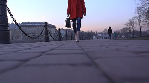 Woman in High Heels Walking Down City Sidewalk