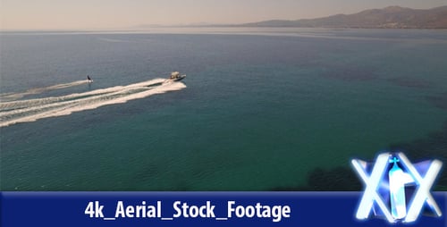 Water Skier Towed by Speedboat on Sunny Ocean