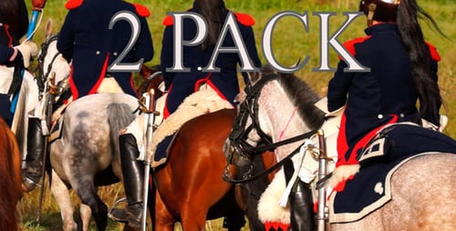 Men Riding Horses Through a Grassy Field