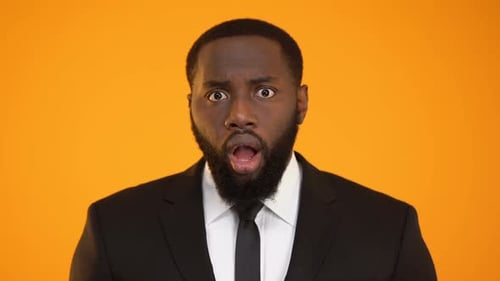 Surprised Man in Suit Reacts to News