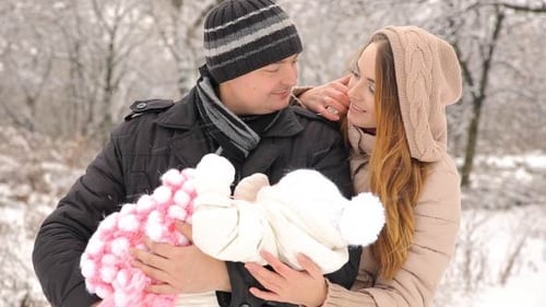 Jeune famille heureuse avec bébé en hiver
