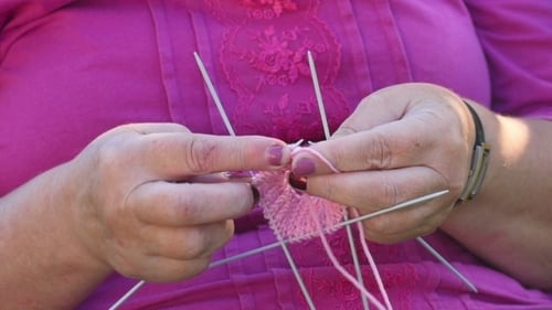 Close-up of Hands Knitting with Yarn and Needles