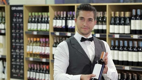 Young Adult Holding Wine Bottle in Store
