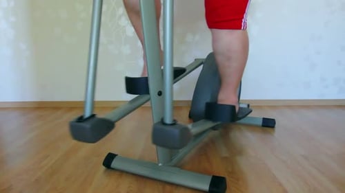 Overweight Woman Legs Exercising On Trainer Ellipsoid 2