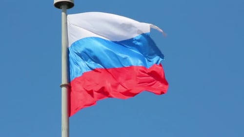 Russian Flag Waving Against Blue Sky Background