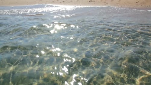 Transparent Sea Water In Shallow Glare From Sun