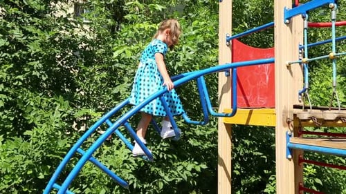 Little Girl Climbs The Stairs On The Playground 2