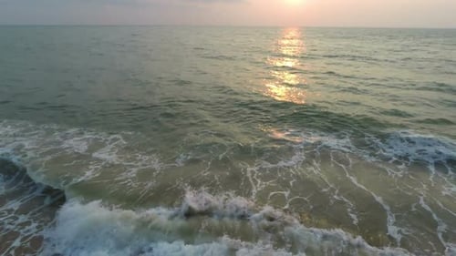 Flying Over Sand Beach At Sunset
