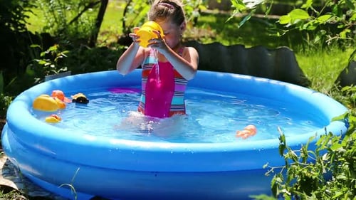 Cheerful Girl In Inflatable Pool In Summer Garden 5