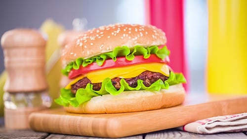 Juicy Hamburger on Cutting Board Close Up