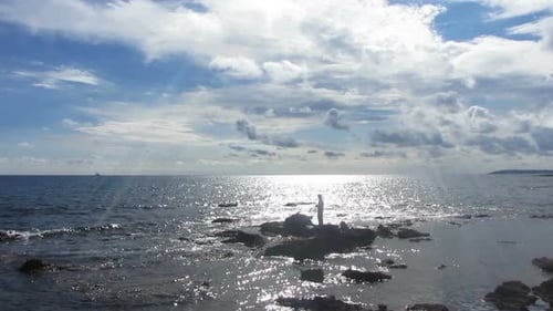 Fisherman Spinning Near Sea In Sunlight