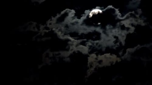 Dramatic Moon Emerges From Dark Night Clouds