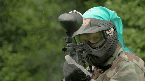 Paintball Player Aiming and Firing a Paintball Gun