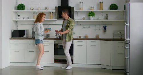 Couple Talking in White Kitchen
