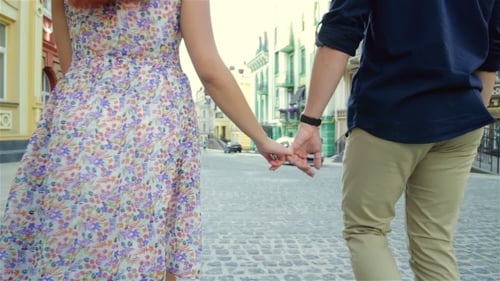 Couple Strolling Hand By Hand In The City