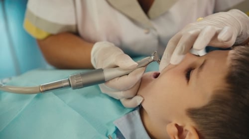 Young Boy Receiving Dental Treatment