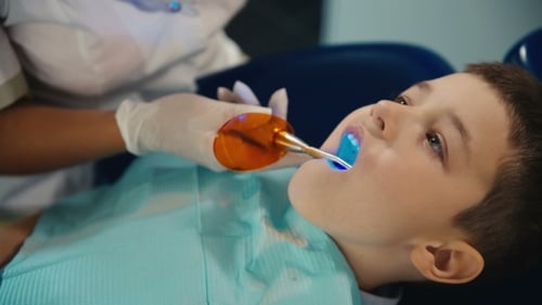 Boy Receives Dental Treatment from Dentist