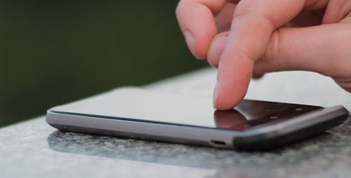 Finger Interacting with Mobile Phone Touchscreen