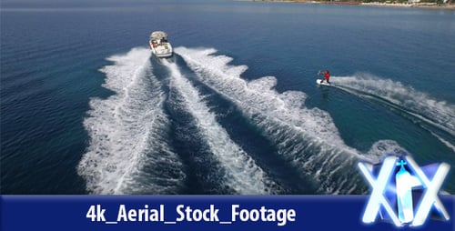 Wakeboarder Rides A Board On The Sea In The Sunny