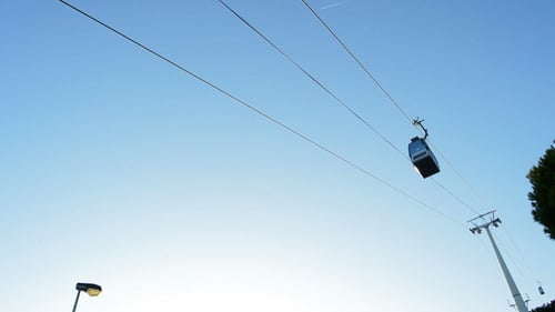 Cable Car Cabins Move Against Blue Sky