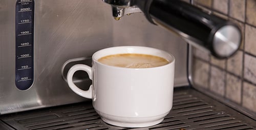 Espresso Coffee Pours Into a White Mug