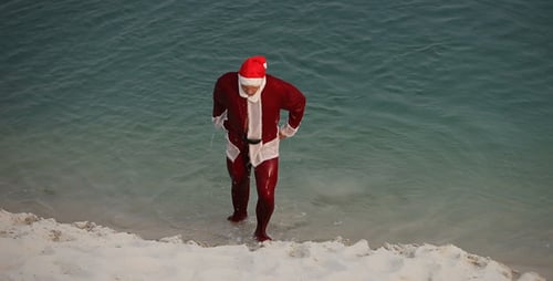 Santa Claus Swimming at the Beach on Christmas