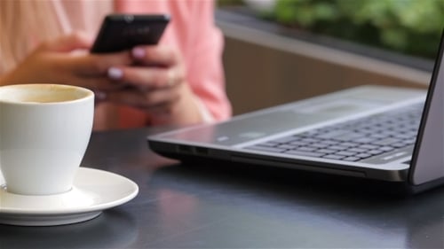 Girl Using Her Mobile Phone In Cafe