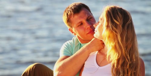 Romantic Couple Embracing at Beach During Sunset