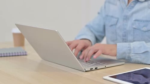 Close Up of Man Typing on Laptop