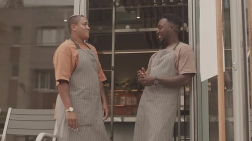 Waiters Chatting Outside Cafe