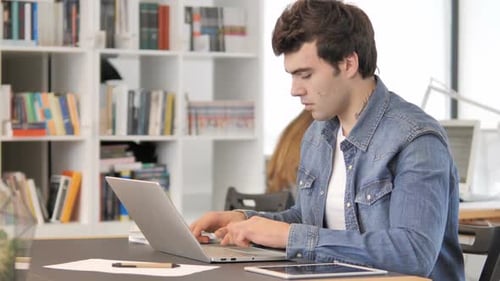 Creative Man Working on Laptop in Office