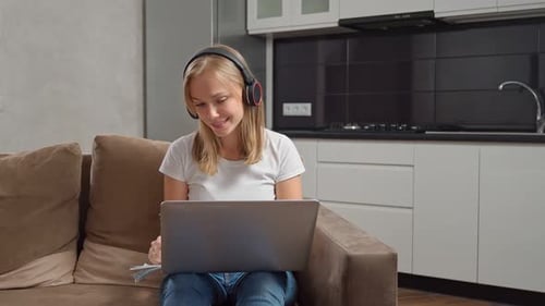 Woman Working on Laptop at Home in Apartment