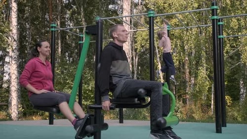 Sporty Family Working Out on an Outdoor Gym