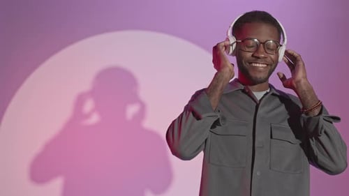 Man Listening to Music with Headphones and Smiling