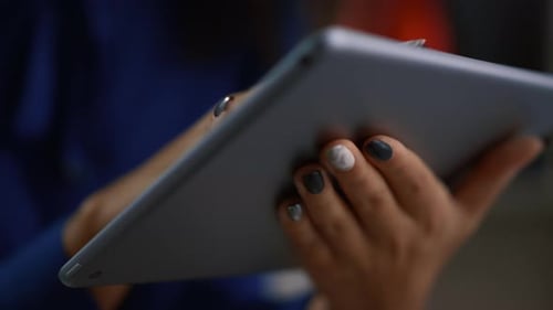 Woman Hands Using Tablet Device Surfing Web Internet in Remote Modern Office