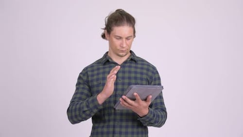 Excited Man Celebrating with a Tablet in Studio