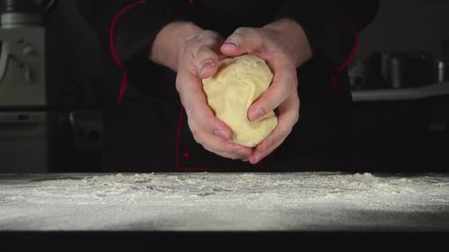 Chef Kneads Dough in Kitchen, Close Up
