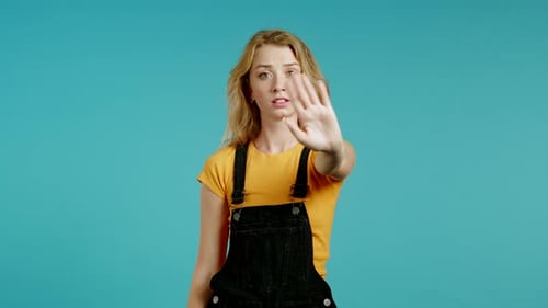 Blonde Woman Posing with Hand in Stop Gesture