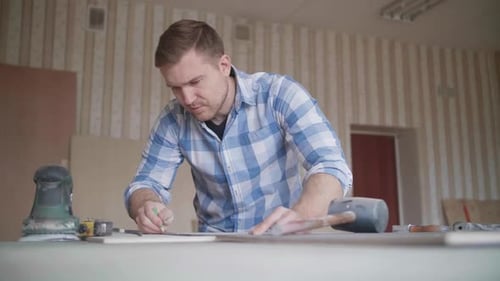 Carpenter Makes Pencil Markings on the Blank with the Help of a Ruler